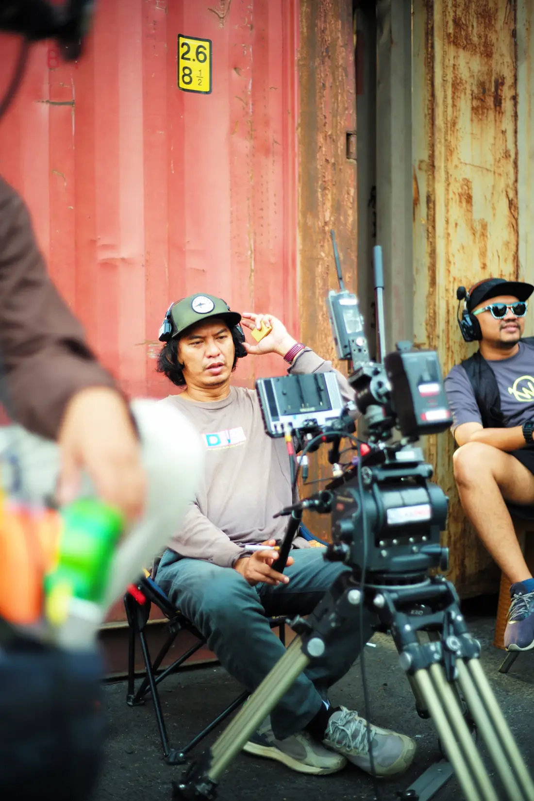 Film crew gathered around a camera rig between takes